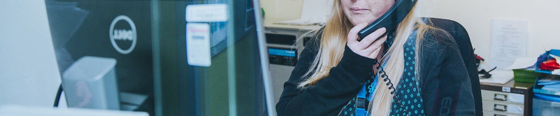 Receptionist speaking on the phone.